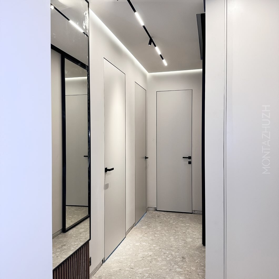 White hidden door system in modern hallway